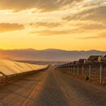 Wide cinematic view of a utility-scale solar farm comparing fixed tilt and single axis tracker mounting systems in a desert landscape during golden hour.